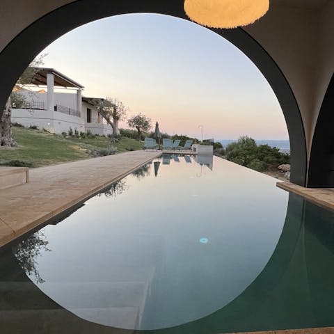 Swim towards the sunset in the infinity pool, partially covered by a unique loggia