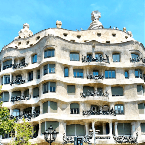 Visit the undulating rooftoops of Casa Milà, a five-minute walk from home