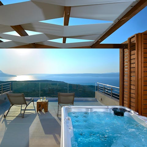 Relax in the hot tub while watching the sun set over the horizon come evening time 