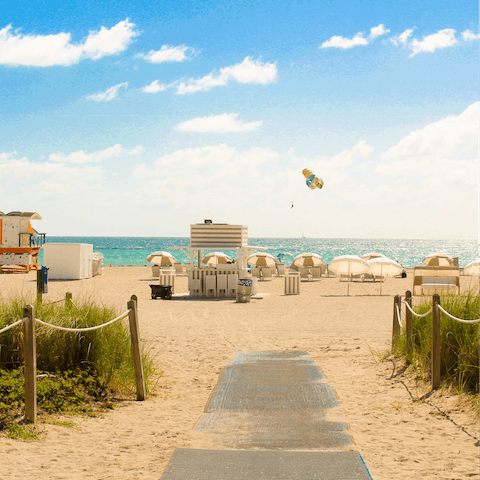 Walk one minute to the soft white sand of Miami Beach 