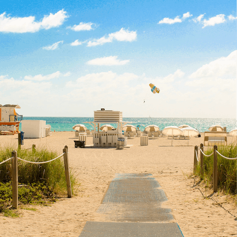 Walk one minute to the soft white sand of Miami Beach