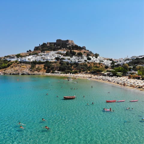 Stay in the gorgeous village of Lindos, with its sandy beach and ancient ruins