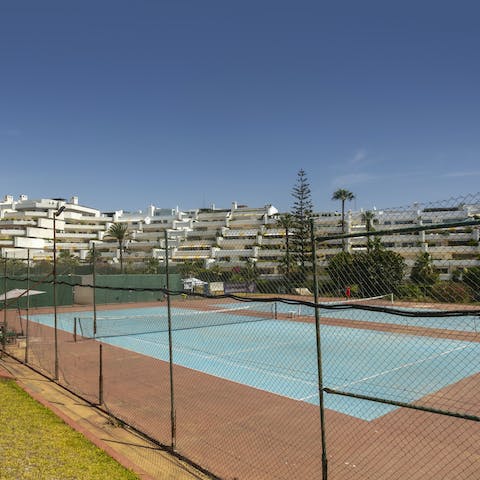 Unleash your competitive side with a game of tennis on the shared courts