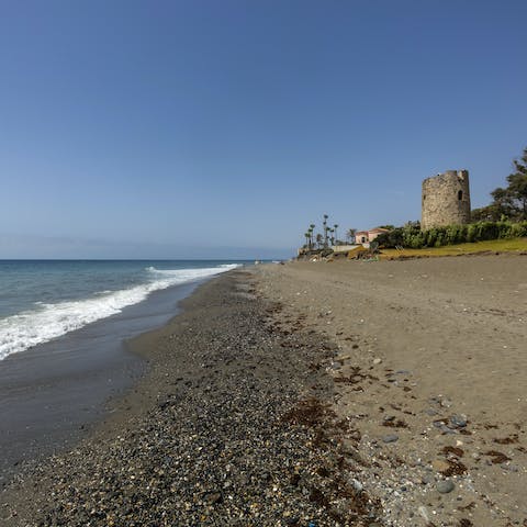 Visit the Torre de las Bóvedas before sinking your toes in the sand at Playa de Linda Vista