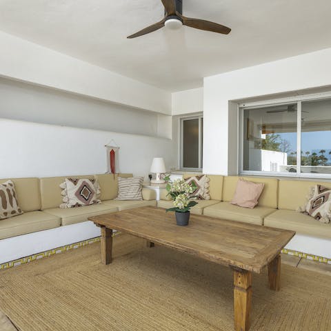 Retreat from the heat with a shaded drink on the terrace's covered sofa area
