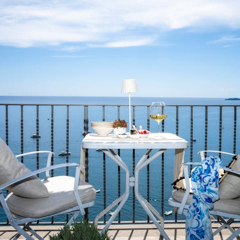 Admire the incredible sea views over a glass of wine