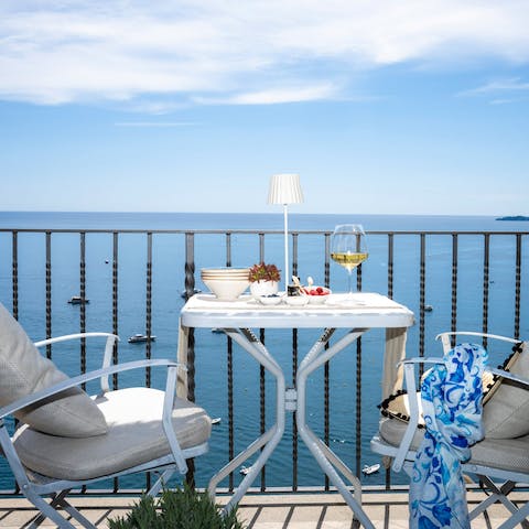 Admire the incredible sea views over a glass of wine