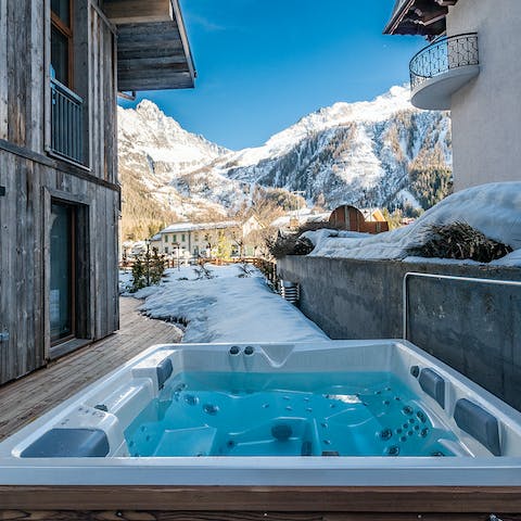 Sip on a nice glass of wine in the bubbling hot tub, overlooking the snowy mountain view