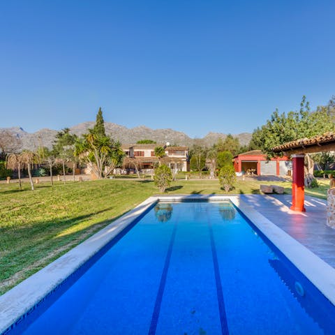 Cool off with a refreshing dip in the outdoor pool surrounded by gorgeous greenery 