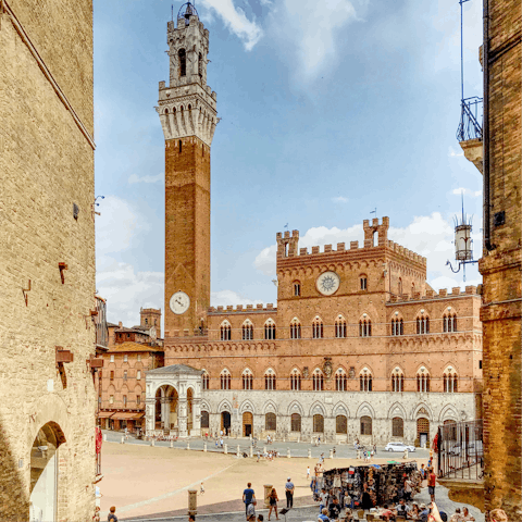 Visit the central square, Piazza del Campo, in Siena