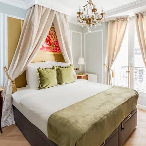 Get some rest in the bedroom with its lovely canopy and chandeliers