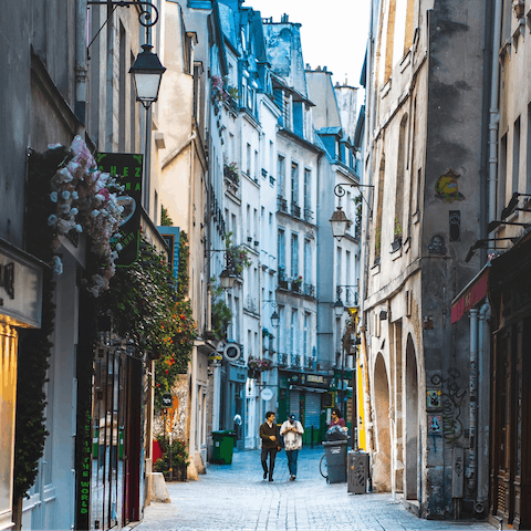 Explore the winding streets of the charming Le Marais district of Paris 