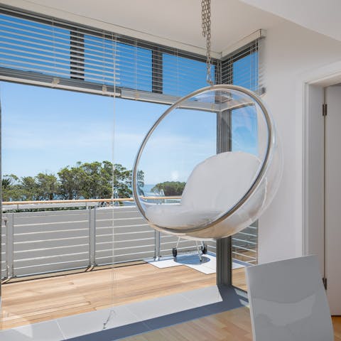 Relax in front of the sparkling seascape from the elevated swing chair