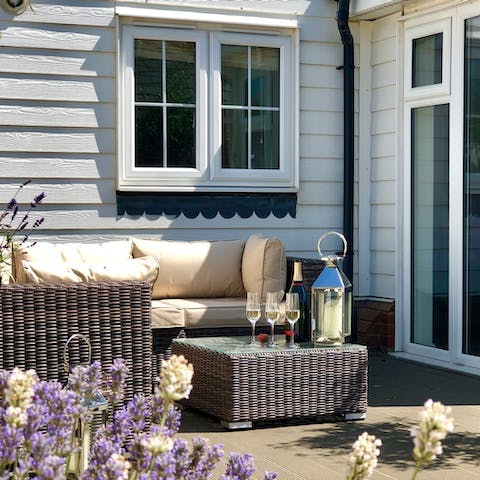 Pop open a bottle of fizz and relax on the outdoor lounge chairs