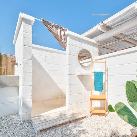 Jump in the outdoor shower after an afternoon swimming in the pool