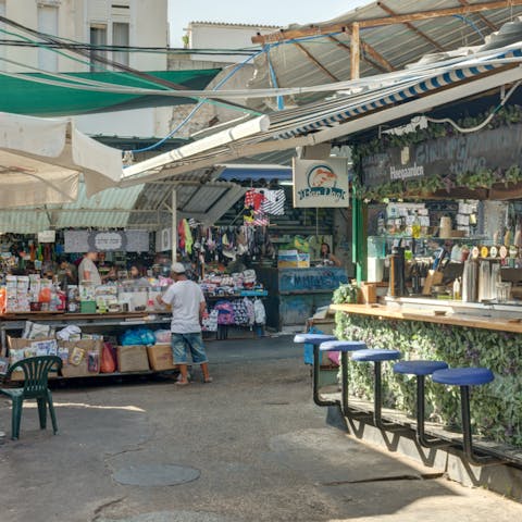 Visit Carmel Market and browse the stalls