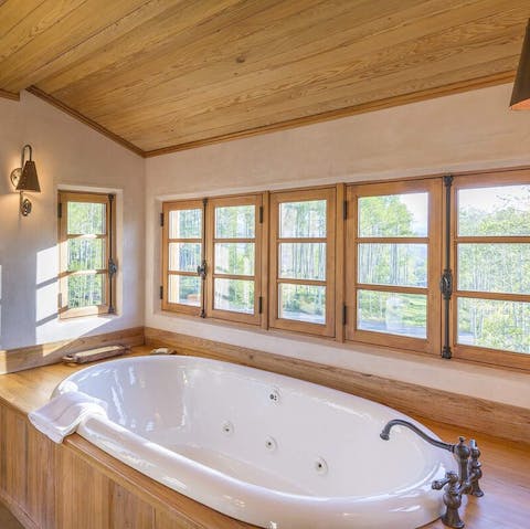 Relax in the jacuzzi-style tub without missing the view