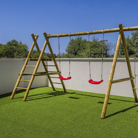Play on the swing set after driving to the Adriatic coast, four kilometres away