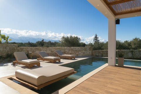 Cool off in the pool after snoozing on a comfortable sun lounger