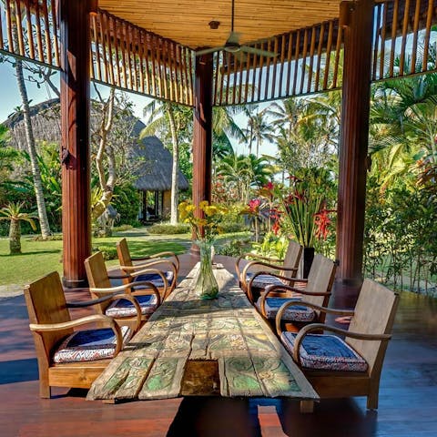 Dine alfresco under the shade of the pergola, surrounded by beautiful scenery