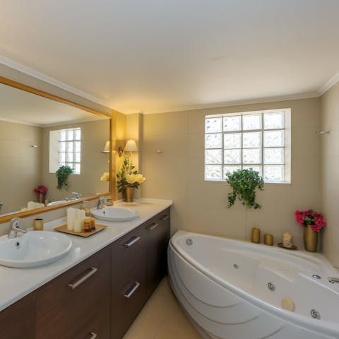 Feel your cares melt away in the corner bathtub after a busy day