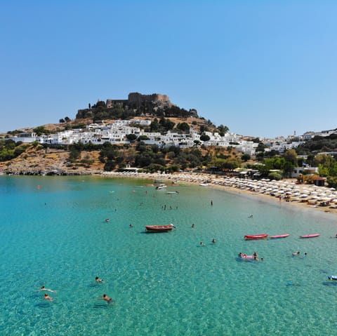 Visit the iconic clifftop acropolis at Lindos, just a short drive south