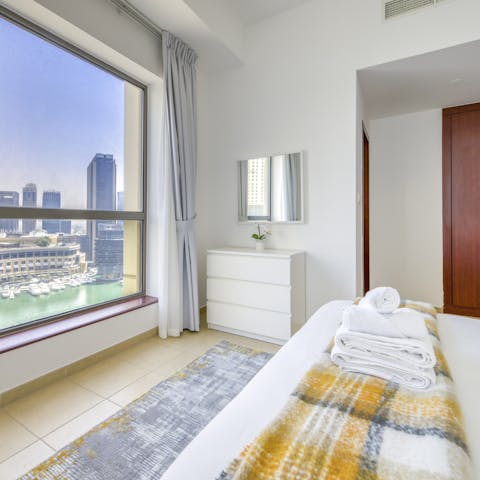 Wake up to sunlit views of the marina in the stylish bedroom