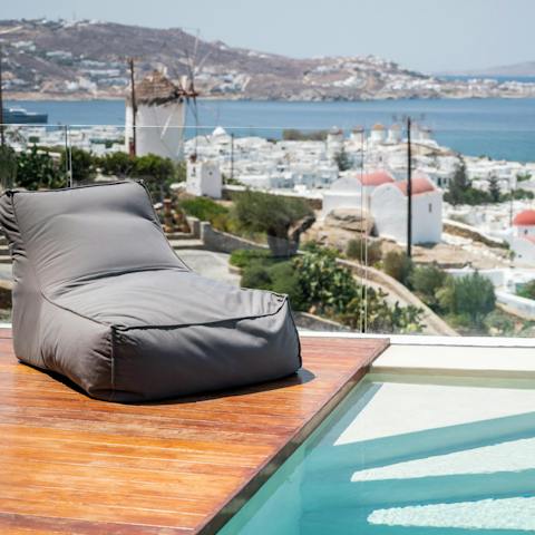 Relax on the day bed while taking in views over the Mykonos rooftops 