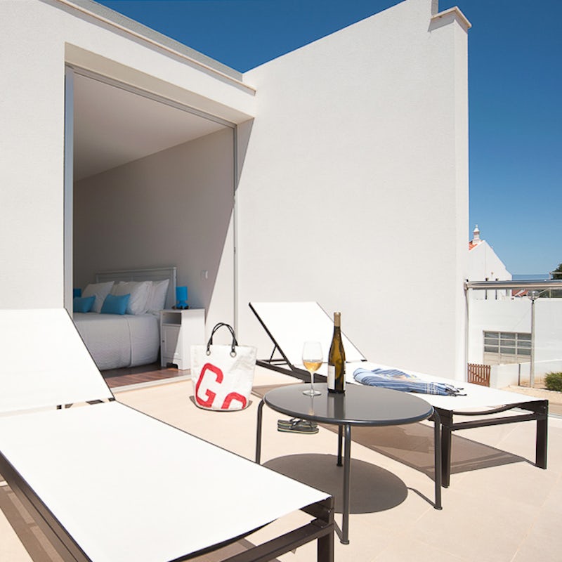 Watch the sunset with a drink on the first-floor balcony