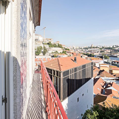 Step out onto the slender balcony and admire the red rooftops of historic Porto