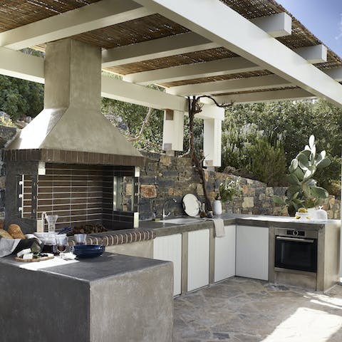 Whip up some culinary masterpieces in the outdoor kitchen, with built-in grill and shelter from the sun