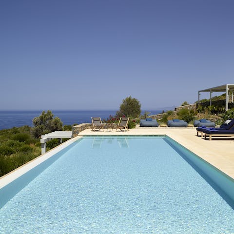 Go for a dip in the pool with the backdrop of the stunning seas before you and the mountain views of Elounda behind you