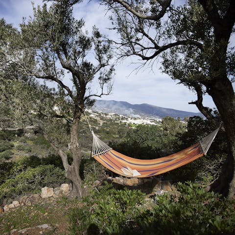 Relax on the hammock in the Elounda villa estate, beneath clear blue skies