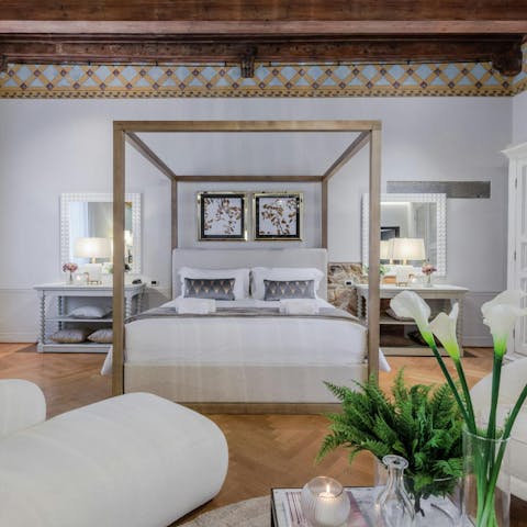 Get some rest in the four-poster bed after a busy day exploring Lucca
