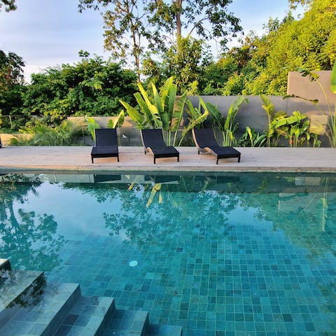 Lay on a poolside lounger before you take a dip in the cool and refreshing water