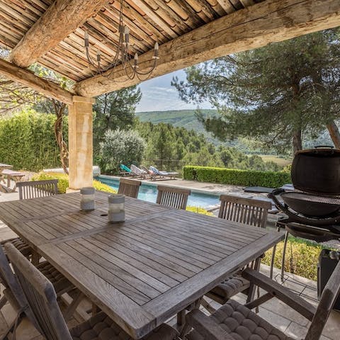 Enjoy communal feasts and French wine in the outdoor dining area 