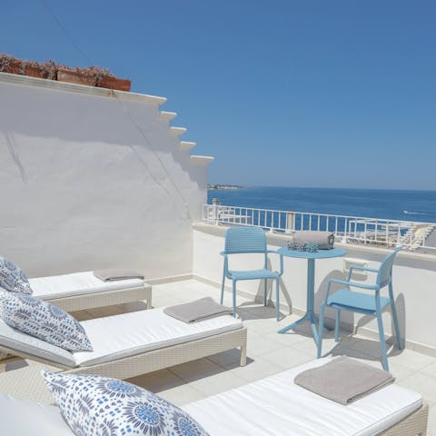 Relax on a lounger as you soak up the sun and sea views