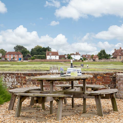 Gather for drinks at the bottom of the garden, overlooking the estuary