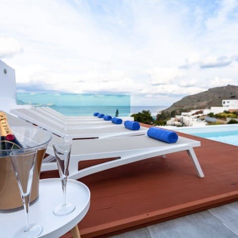 Enjoy expansive views across the coast whilst lounging by the pool