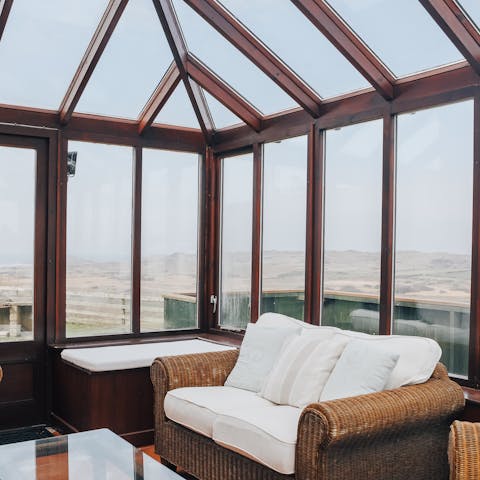 Enjoy the view whatever the weather in the sunny conservatory