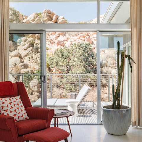 Open the living room's glass sliding doors to step out into the desert