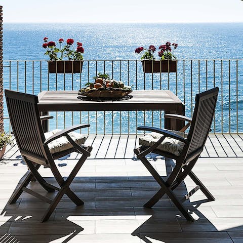 Admire the stunning Mediterranean Sea vistas from the geranium festooned balcony