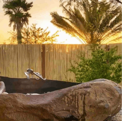 Admire a beautiful sunset from the private hot springs soaking tub