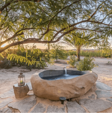 Admire a beautiful sunset from the private hot springs soaking tub