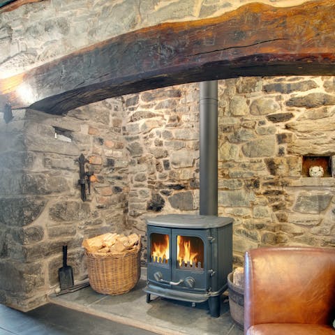 Cosy up by two Inglenook wood-burning fireplaces