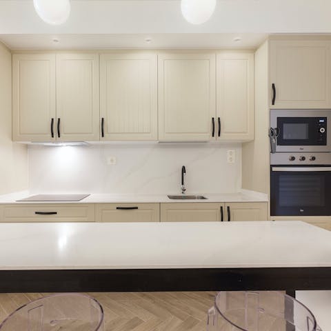 Whip up some delectable seafood paella in the sleek kitchen