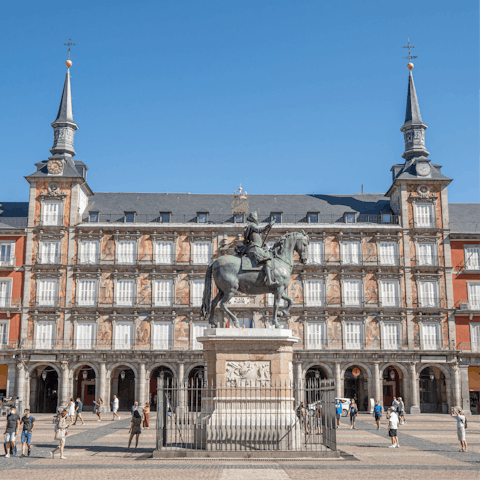 Stroll down to Madrid's bustling Plaza Mayor and see historical statues