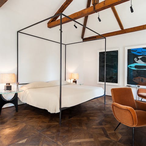 Get some rest in the four-poster bed before heading out for dinner in Piazza San Marco