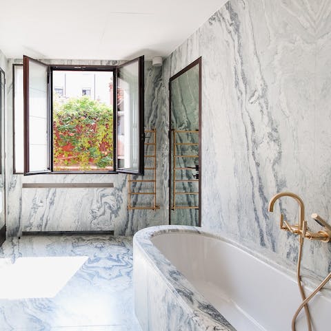 Have a soak in the master bedroom's exquisite marble tub after a busy day exploring Venice