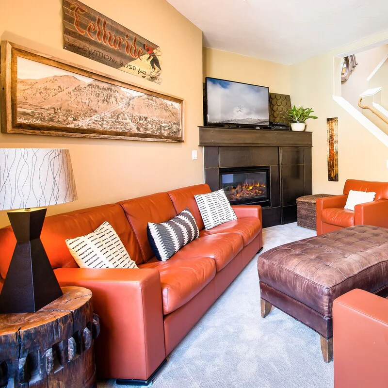 A cosy and comfortable living area with a fireplace to come back to after a day on the slopes